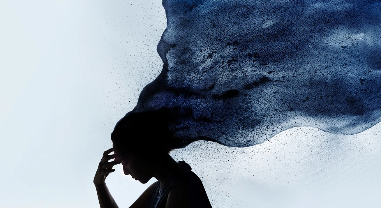 Silhouette of a person with softly dispersing ink, representing mental health
